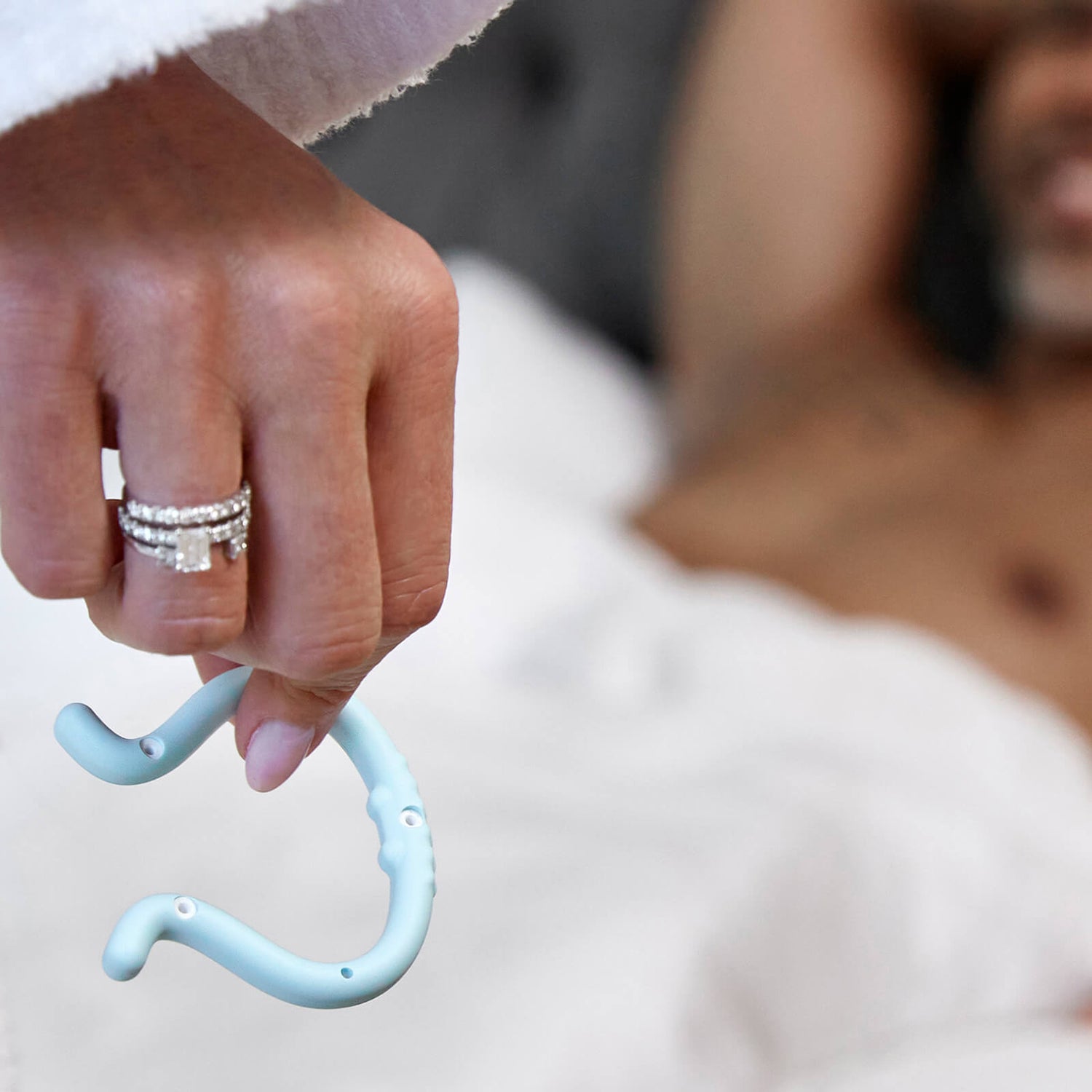 Woman with Wedding Ring Holding Eddie Next to Husband in Bed