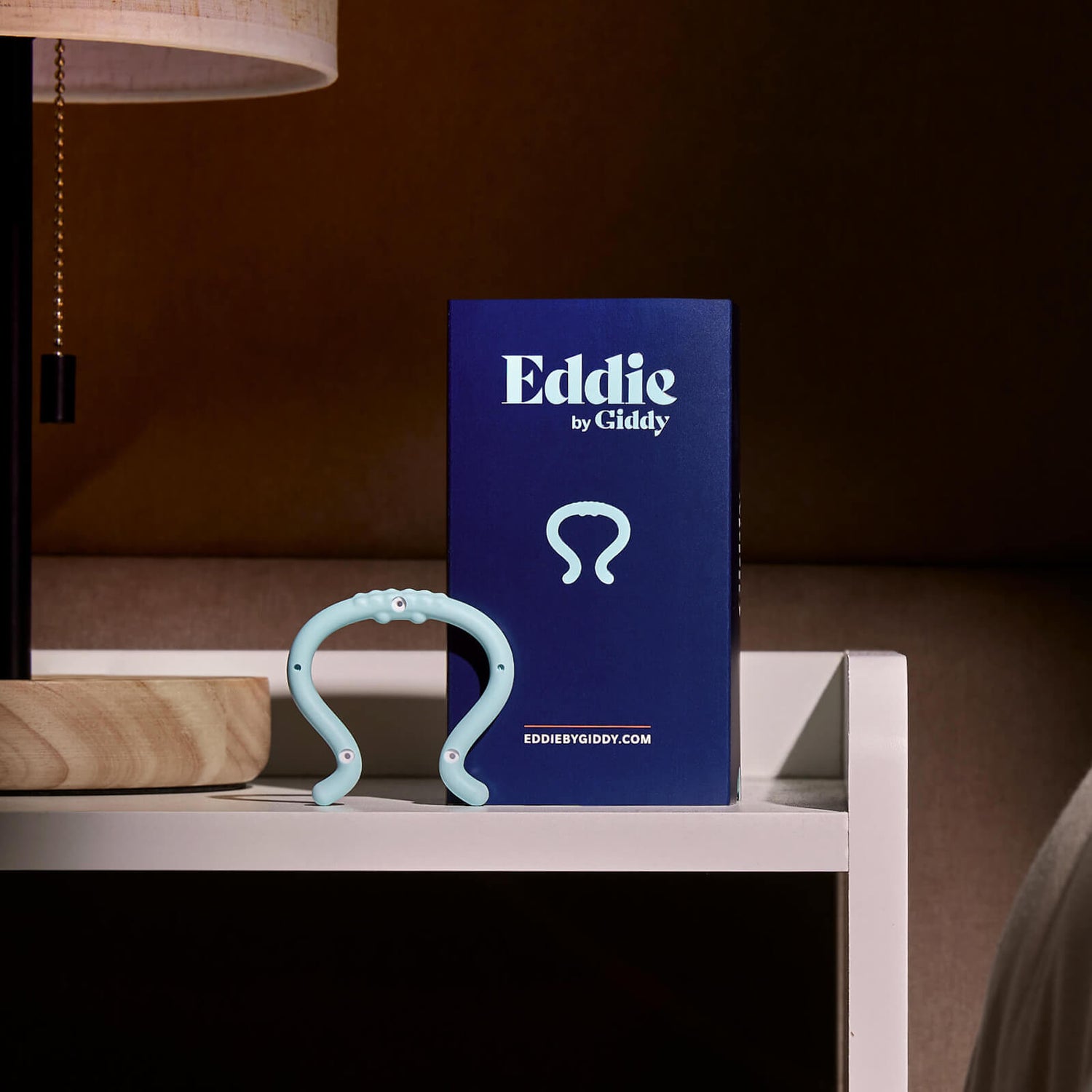 Eddie Product Box with Eddie on Nightstand Next to Lamp